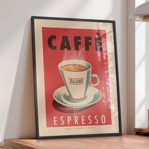 A large framed poster set in a black wooden picture frame. The poster is in a retro Italian Cafe style with red background a large title which reads "Caffè Espresso" and an illustration of a coffee cup and saucer.