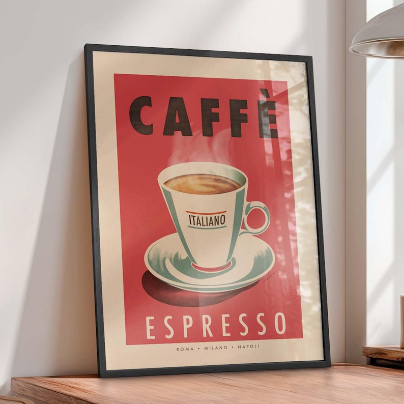 A large framed poster set in a black wooden picture frame. The poster is in a retro Italian Cafe style with red background a large title which reads "Caffè Espresso" and an illustration of a coffee cup and saucer.