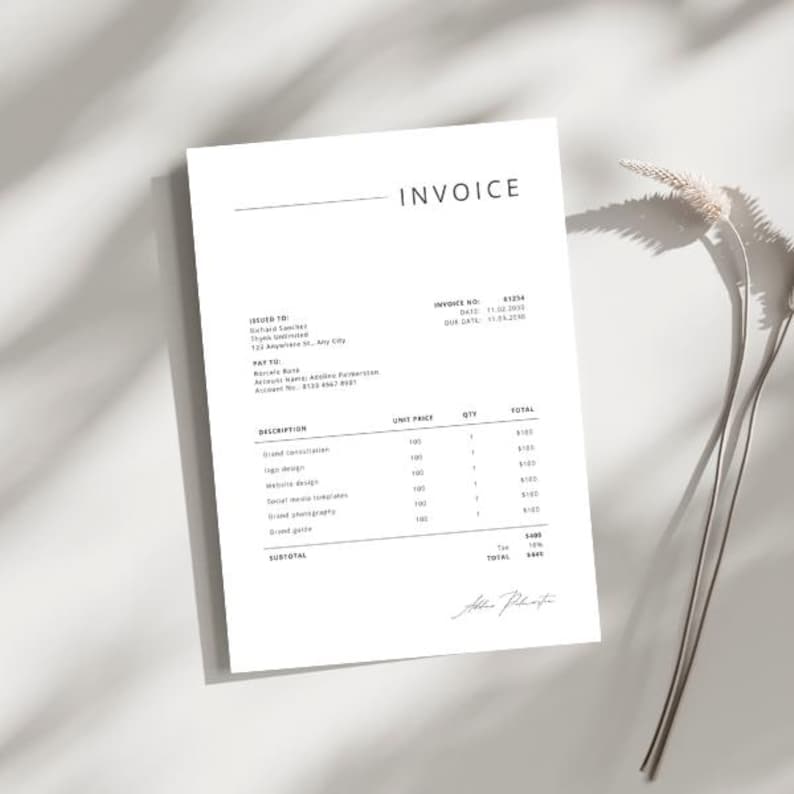 May include: A white invoice with the word "INVOICE" at the top. The invoice includes details such as invoice number, due date, and a list of services with unit prices and totals. A sprig of dried flowers is in the background.