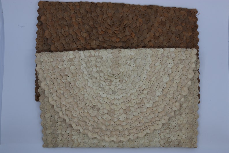 May include: Two leather clutches with a unique geometric pattern. The top clutch is brown and the bottom clutch is white.
