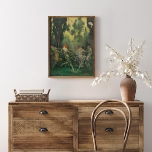 May include: A framed artwork depicts figures dancing in a forest setting. The painting features a palette of greens, yellows, and browns, with a focus on movement and light. The artwork is displayed above a wooden dresser with a woven basket and a vase of white flowers.