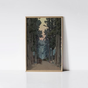 May include: Framed print of a Japanese landscape featuring a path lined with tall trees. The artwork has a vintage aesthetic with muted colors, including greens, blues, and a soft orange sky. The print is in a gold frame.