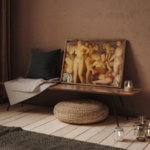 May include: A framed artwork depicting nude figures is displayed on a wooden bench. A dark gray pillow and a striped blanket are on the bench. A woven ottoman and several candle holders are in front of the bench. The room has a warm, inviting atmosphere.