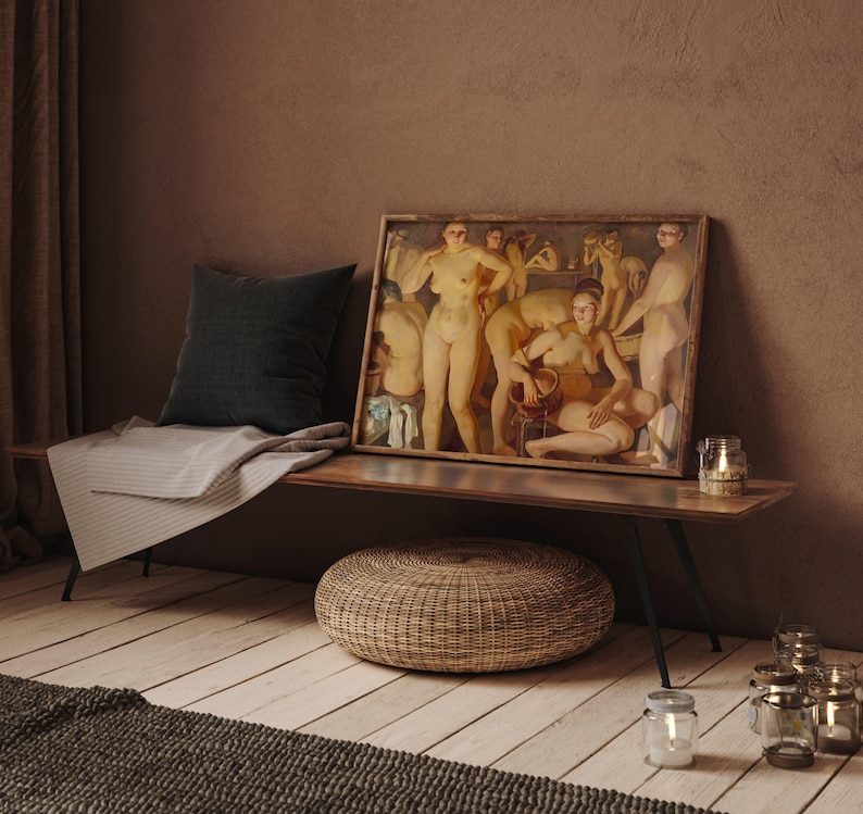 May include: A framed artwork depicting nude figures is displayed on a wooden bench. A dark gray pillow and a striped blanket are on the bench. A woven ottoman and several candle holders are in front of the bench. The room has a warm, inviting atmosphere.