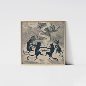 May include: A framed print featuring a vintage illustration of black cats dancing around a fire under a full moon. A witch is perched in a tree, and a bat flies in the sky. The artwork has a sepia tone and is framed in a gold-colored frame.