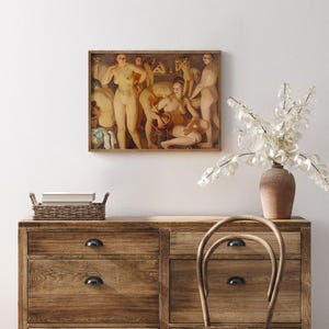 May include: A framed artwork depicting a classical scene of nude figures in a bathhouse setting. The painting features warm tones and detailed figures, mounted on a light-colored wall above a wooden dresser.