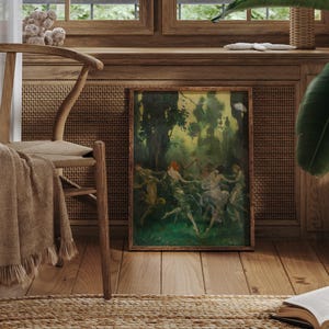 May include: A framed artwork depicting a group of figures dancing in a forest setting. The painting features a palette of greens, browns, and hints of red, with a wooden frame. The artwork is displayed near a wooden chair with a tan throw and a woven rug.