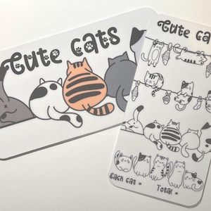 May include: Two white rectangular cards with rounded corners. One card features three cartoon cats with their backs facing the viewer, and the text "Cute cats". The other card has multiple cat illustrations and the text "Cute cats".
