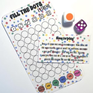 May include: A clear plastic game board with the text "FILL THE DOTS EXTREME" and a series of circles. Two dice, one white with an orange dot and one purple with white dots, are next to the board. A card with instructions is also included.
