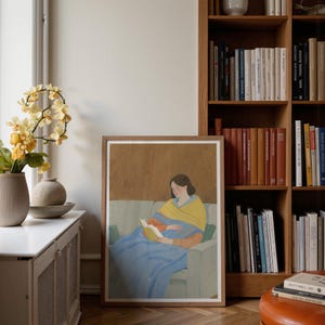 Portrait wooden frame mockups leaning against an oak bookcase in a cozy Scandinavian-style reading nook — soft natural window light, hardwood floor, decorative vases and orchids on a console; styled home decor and print mockups for listings.