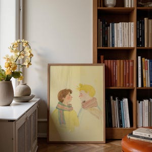 Portrait wooden frame mockups leaning against an oak bookcase in a cozy Scandinavian-style reading nook — soft natural window light, hardwood floor, decorative vases and orchids on a console; styled home decor and print mockups for listings.