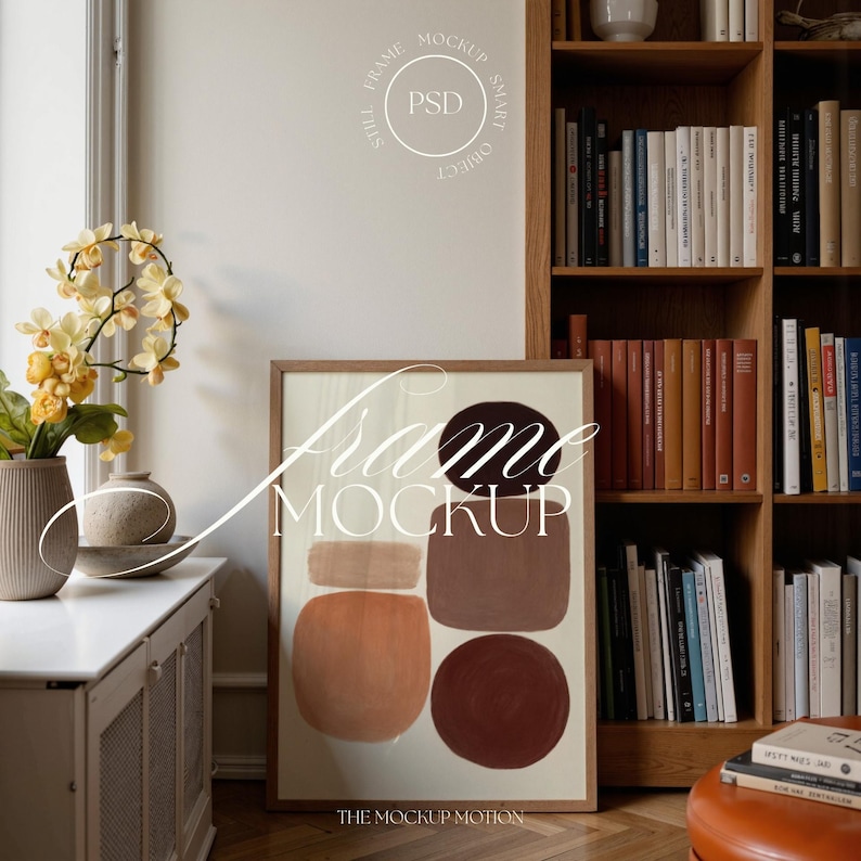Portrait wooden frame mockups leaning against an oak bookcase in a cozy Scandinavian-style reading nook — soft natural window light, hardwood floor, decorative vases and orchids on a console; styled home decor and print mockups for listings.