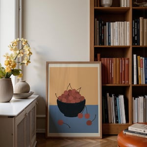 Portrait wooden frame mockups leaning against an oak bookcase in a cozy Scandinavian-style reading nook — soft natural window light, hardwood floor, decorative vases and orchids on a console; styled home decor and print mockups for listings.