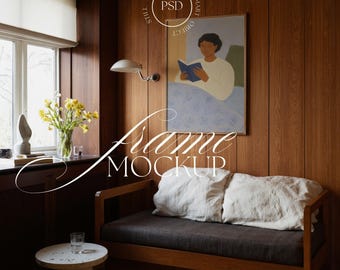 May include: A room interior with a wooden daybed, a framed artwork, and a small side table. The artwork depicts a person reading a book. The words "Frame Mockup" are written across the image. The room has wooden paneling.