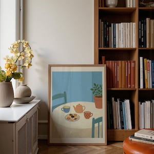 Portrait wooden frame mockups leaning against an oak bookcase in a cozy Scandinavian-style reading nook — soft natural window light, hardwood floor, decorative vases and orchids on a console; styled home decor and print mockups for listings.