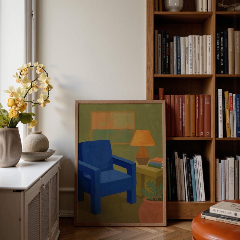 Portrait wooden frame mockups leaning against an oak bookcase in a cozy Scandinavian-style reading nook — soft natural window light, hardwood floor, decorative vases and orchids on a console; styled home decor and print mockups for listings.