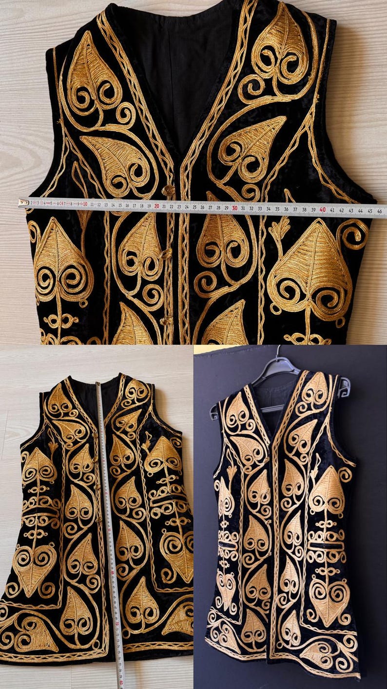May include: Black vest with gold embroidery. The vest features an intricate design of swirling patterns and leaf-like shapes. The vest measures approximately 117 cm in length.