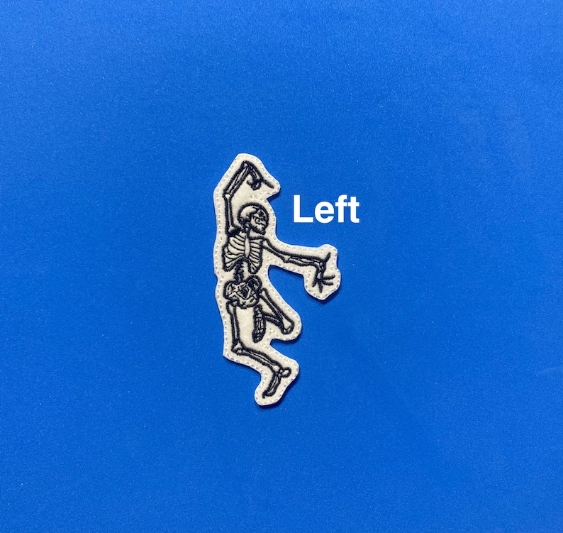 May include: White embroidered patch of a skeleton dancing with the word "Left" in white text.