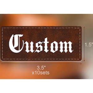 May include: A rectangular brown patch with visible stitching along the edges and the word Custom printed in white gothic lettering. The patch measures 3.5 inches by 1.5 inches and is part of a set of 10 sets as indicated by the text on the image.