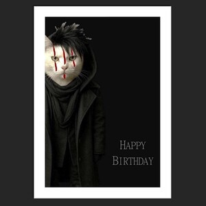 May include: A birthday card showing a white cat with black hair and red face paint, wearing a black coat and scarf. The words "HAPPY BIRTHDAY" are printed in white. The background is black.