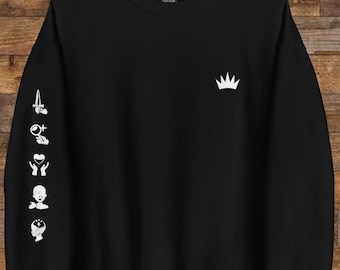 May include: Black sweatshirt with a white crown on the front and a series of white symbols on the left sleeve. The symbols include a dagger, a magnifying glass, a hand with a heart, a face, and a head with a circle around it.