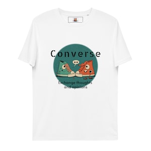 Puede incluir: Camiseta blanca con un círculo verde y la palabra "Converse" en texto negro. Dentro del círculo hay dos zapatos Converse de dibujos animados con caras, hablando entre sí. El texto "Intercambiar pensamientos y opiniones" está debajo del círculo.