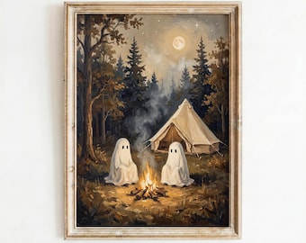May include: A framed wall art print depicting two white ghosts sitting by a campfire in a dark forest at night. A beige canvas tent stands in the background under a full moon and starry sky. The text Arty Nest Prints appears at the bottom.