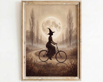 May include: A framed wall art print featuring a sepia-toned illustration of a figure in a pointed hat riding a bicycle along a dirt path. A large full moon hangs in the sky above tall trees and low bushes. The text Artly Nest Prints appears below.