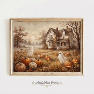 May include: A framed wall art print depicting a sepia-toned landscape with a large house, a field of orange pumpkins, and two white ghost figures. The scene features a full moon in the sky, bare trees, and the text Artly Nest Prints at the bottom.