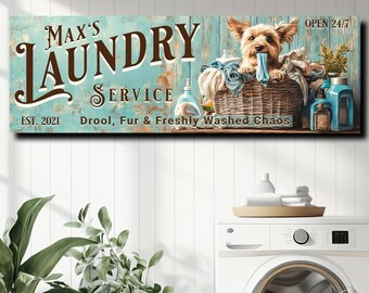 May include: A vintage-style sign for a laundry service with the name "Max's Laundry Service" and the text "EST. 2021 Drool, Fur & Freshly Washed Chaos"  A small dog is sitting in a basket with laundry, and the sign says "Open 24/7".