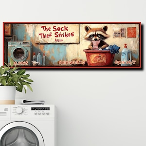 May include: A vintage-style sign with a raccoon wearing a red sock and holding a bucket of laundry. The sign reads "The Sock Thief Strikes Again" and "Help Wanted" with a red and white striped awning. The sign is set against a backdrop of a laundry room with a washing machine and detergent bottles.