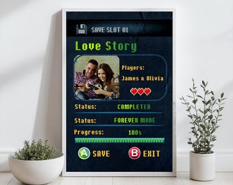 May include: A framed print with a video game theme. The design features a photo of a couple, the text "Love Story", and game-like status indicators. The print includes the text "SAVE SLOT 01", "Players: James & Olivia", "Status: COMPLETED", and "FOREVER MODE".