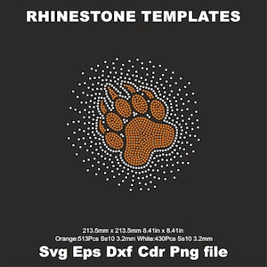 May include: A rhinestone template of a brown bear paw print with white rhinestones around the edge. The template is 8.41 inches by 8.41 inches and uses 513 orange rhinestones and 430 white rhinestones.