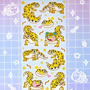 May include: A sheet of stickers featuring various cartoon leopard geckos in different poses. The stickers are on a white background with yellow stars and pink hearts. The text "hecko gecko" is at the top of the sheet.