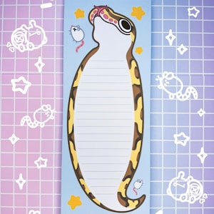 May include: A blue notepad with a yellow and brown snake illustration. The snake is looking up and has a pink tongue. There are small white mice and yellow stars around the snake.