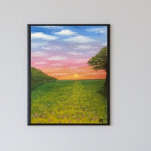May include: A painting of a sunset over a field of green grass with a single tree on the right side of the image. The sky is a mix of pink, orange, and blue.