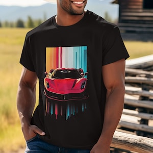 May include: A black t-shirt with a red sports car graphic against a colorful striped background. The car is a Ferrari with a red body and black wheels.