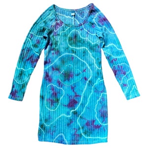May include: A long-sleeved, blue and purple tie-dye dress with a scoop neck and ribbed fabric.