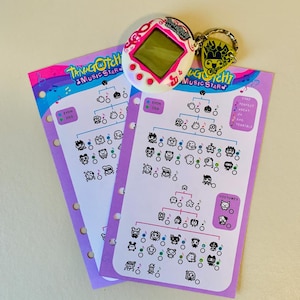 May include: A white and pink Tamagotchi Music Star digital pet with a keychain and two purple evolution charts. The charts feature character illustrations and the text "Tamagotchi Music Star".