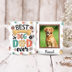 May include: White ceramic mug with a colorful design that says "Best Dog Dad Ever" and a paw print. The mug has a photo of a golden retriever dog named Peanut.
