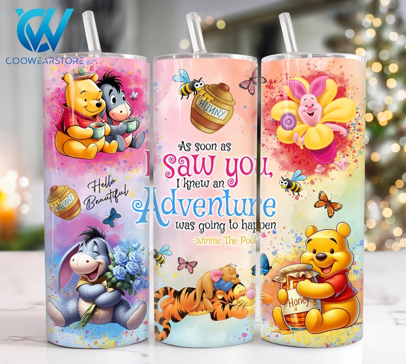 May include: Three stainless steel tumblers with colorful designs featuring Winnie the Pooh and his friends. The tumblers have lids and straws. The designs include Winnie the Pooh and Piglet, Winnie the Pooh and Tigger, and Winnie the Pooh and Eeyore. The tumblers have quotes from Winnie the Pooh.