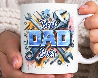 May include: White ceramic mug with a watercolor design of tools and the text "Best Dad Ever" in blue letters.
