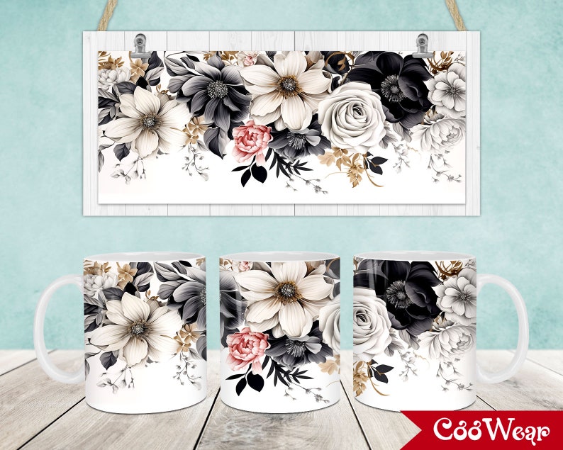 May include: Three white ceramic mugs with a floral design featuring black, white, and blush-colored flowers. A rectangular sign with the same floral design hangs above the mugs. The design includes gold accents and is set against a white background.