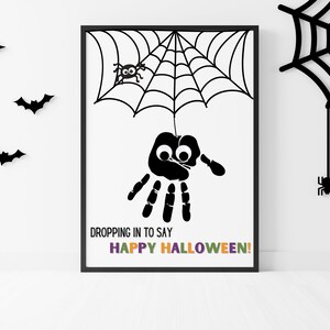 Pode incluir: Artesanato de Halloween imprimível em preto e branco com uma aranha de impressão digital pendurada em uma teia de aranha. O texto diz "Dropping in to say Happy Halloween!"