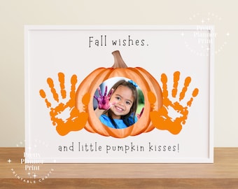 May include: A printable autumn-themed craft featuring a pumpkin cutout, a child's handprint, and the text "Fall wishes. and little pumpkin kisses!"