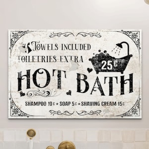 May include: Black and white vintage-style sign with the text "TOWELS INCLUDED TOILETRIES EXTRA HOT BATH SHAMPOO 10c SOAP 5c SHAVING CREAM 15c" and a cartoon image of a bathtub with bubbles and a shower head.