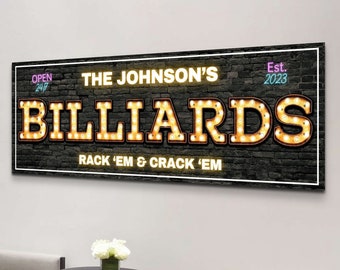 May include: A black and white sign with a brick background and the text "The Johnson's Billiards Est. 2023 Open 24/7 Rack 'Em & Crack 'Em" in a neon-style font with yellow lights.