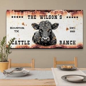 May include: Rustic metal sign with a black and white illustration of a cow's head. The sign reads "The Wilson's Cattle Ranch, Houston TX, Est. 2023".