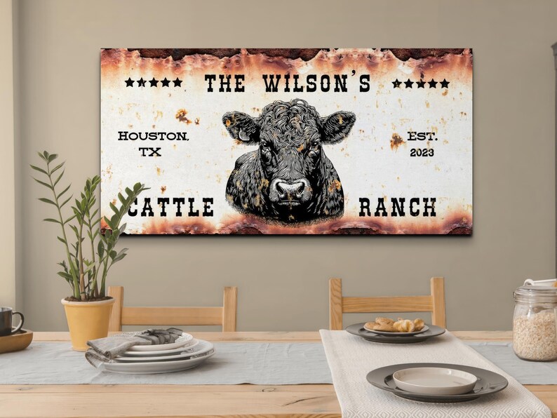 May include: Rustic metal sign with a black and white illustration of a cow's head. The sign reads "The Wilson's Cattle Ranch, Houston TX, Est. 2023".