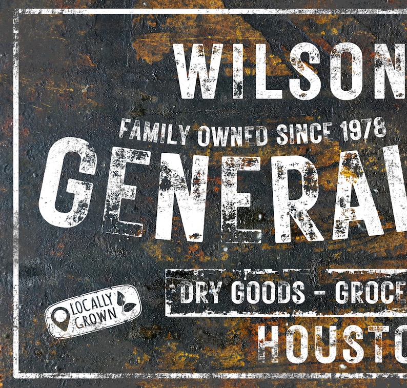 May include: A vintage-style metal sign with a distressed, rusty look. The sign reads "Wilson Family Owned Since 1978 General Dry Goods - Groceries Houston". The sign has a white background with black lettering and a green leaf logo that says "Locally Grown".